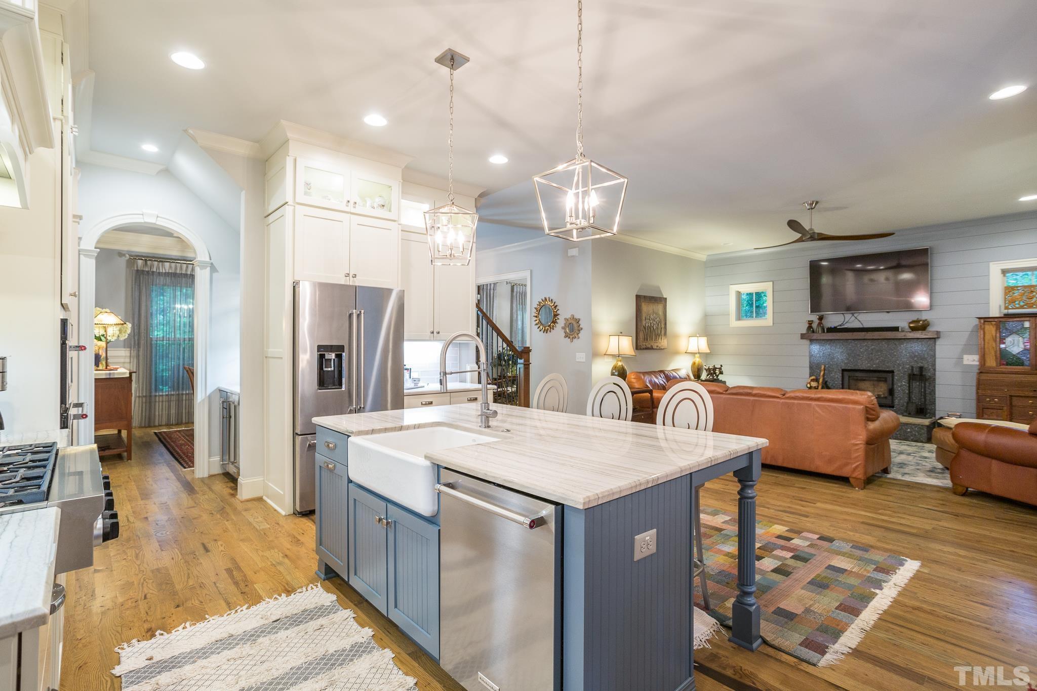 1921 Banbury Road Raleigh, NC 27608 - Photo 14 of 30 a large kitchen with kitchen island a large island in it
