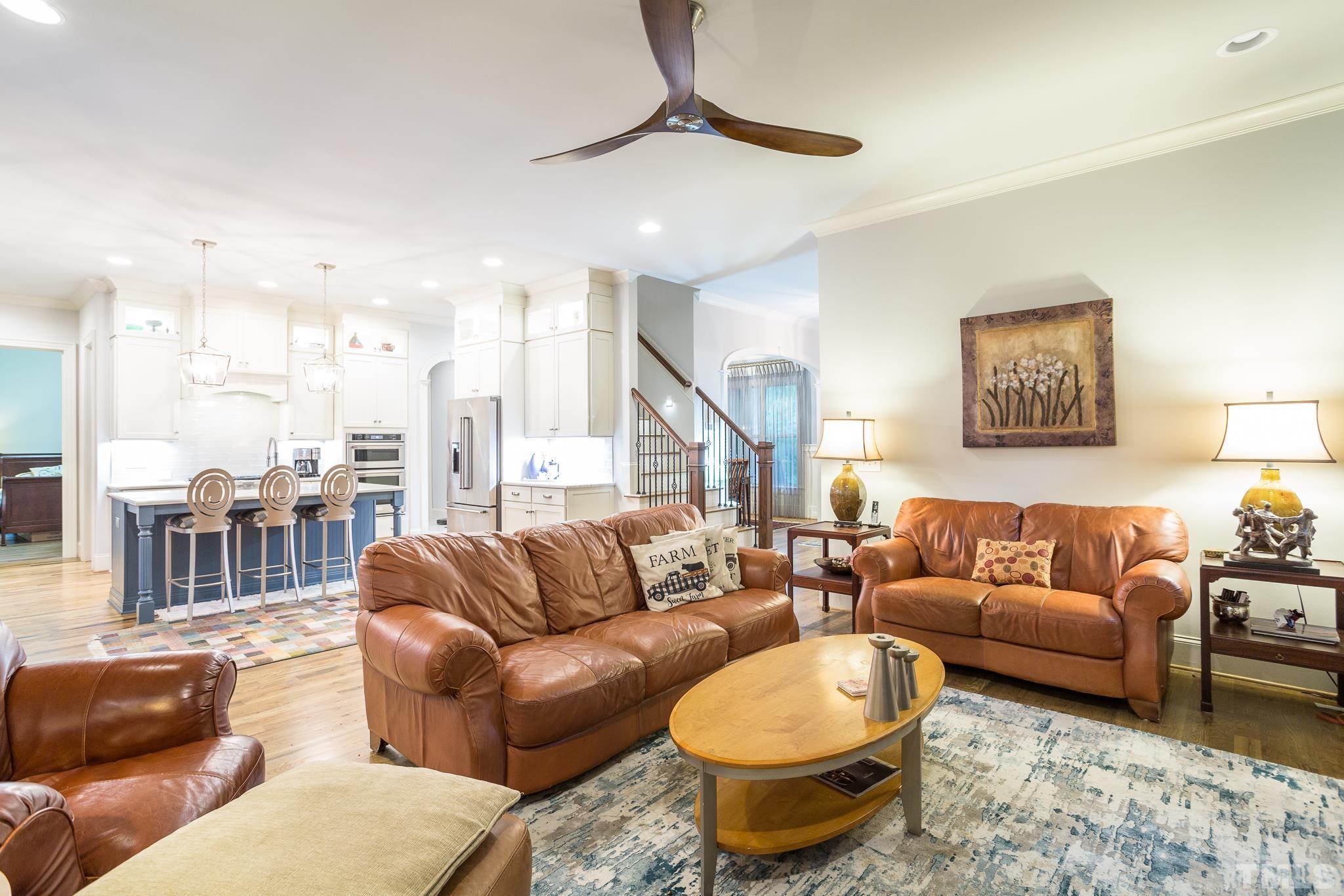 1921 Banbury Road Raleigh, NC 27608 - Photo 16 of 30 a living room with furniture a rug and a chandelier