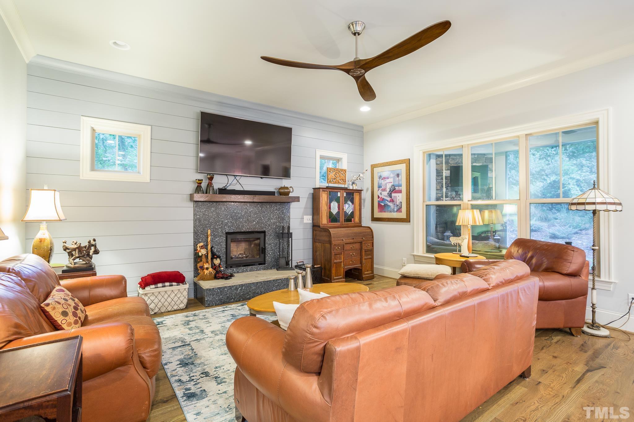 1921 Banbury Road Raleigh, NC 27608 - Photo 17 of 30 a living room with fireplace furniture and a flat screen tv