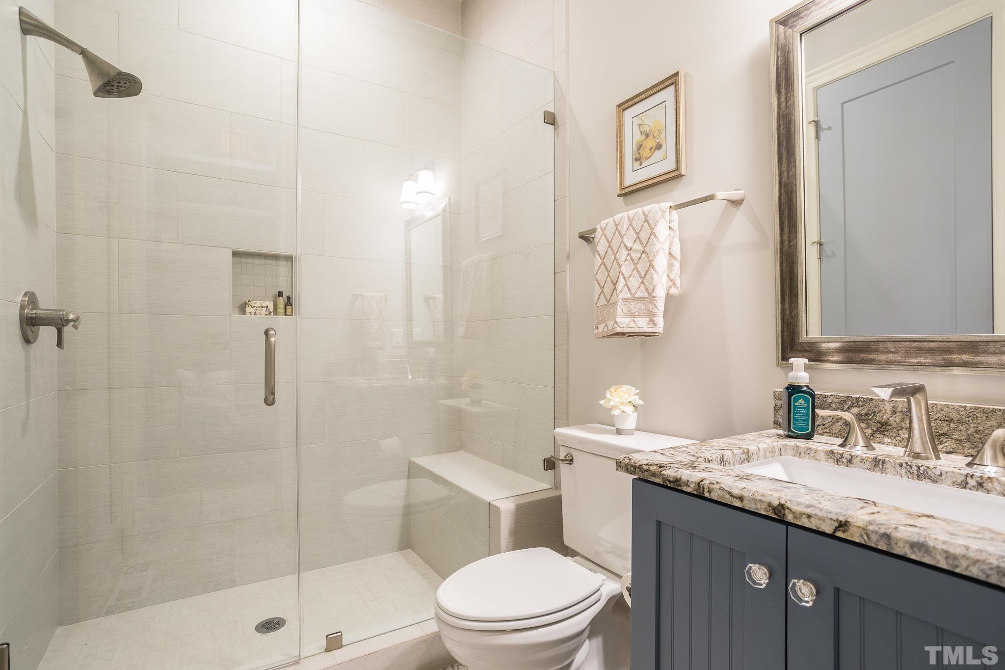 1921 Banbury Road Raleigh, NC 27608 - Photo 20 of 30 a bathroom with a granite countertop sink toilet and shower