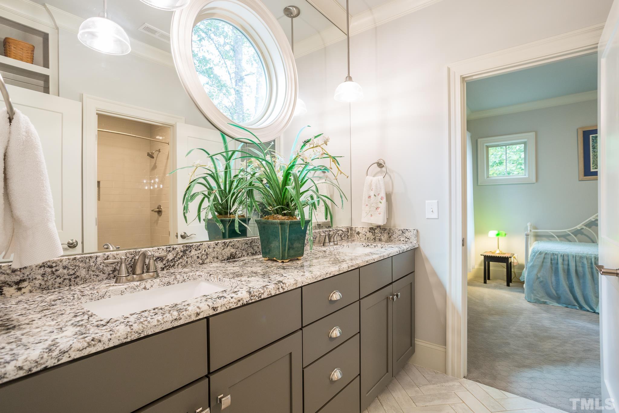 1921 Banbury Road Raleigh, NC 27608 - Photo 25 of 30 a bathroom with a granite countertop sink a mirror and a window