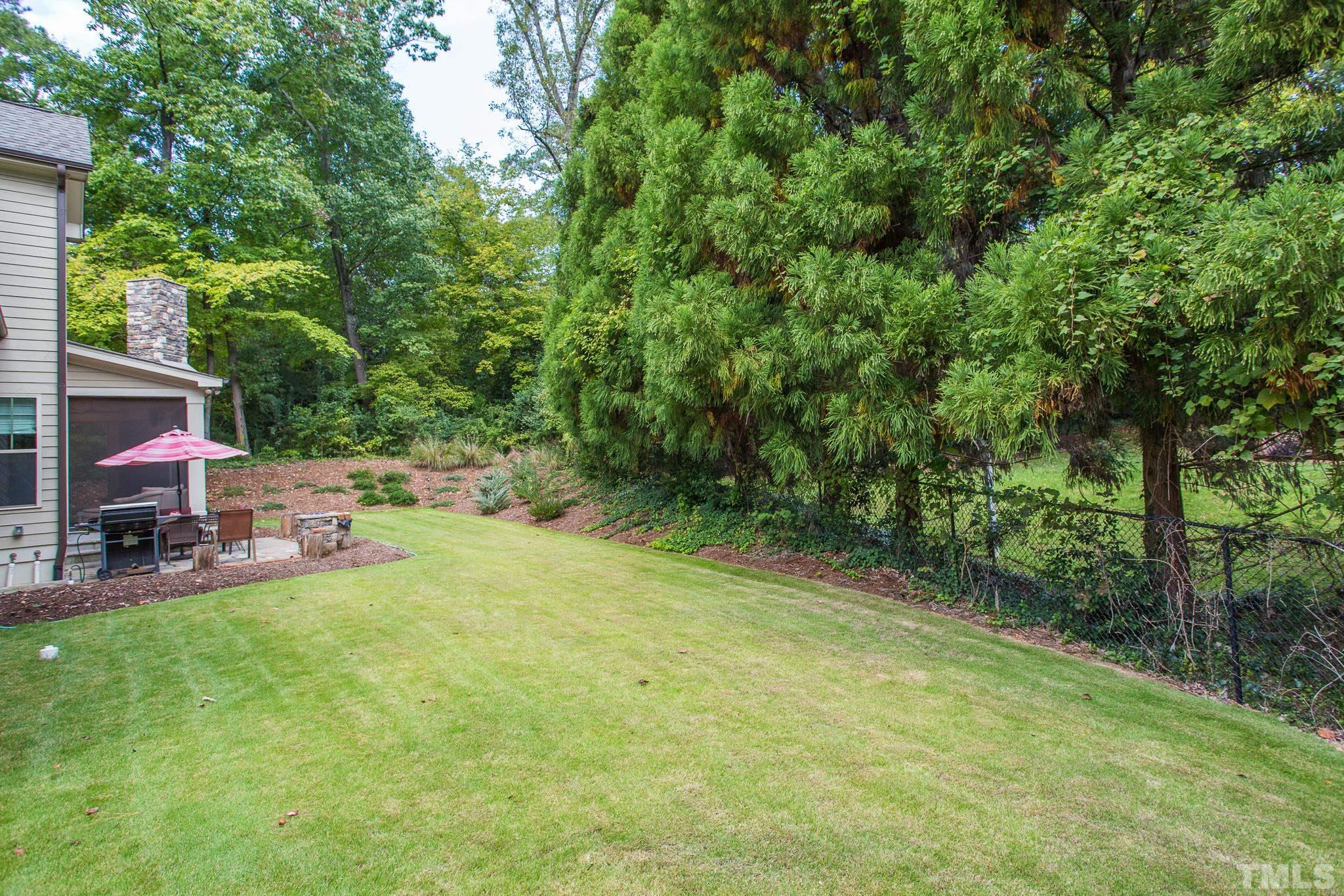 1921 Banbury Road Raleigh, NC 27608 - Photo 5 of 30 a view of backyard with table and chairs a barbeque and a large trees