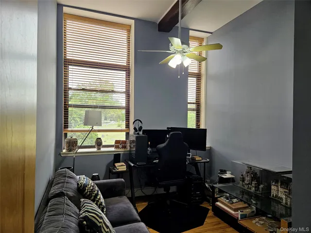 a living room with furniture a chandelier and a window