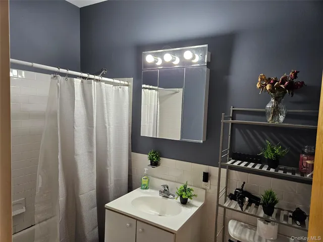 a bathroom with a sink vanity and a mirror