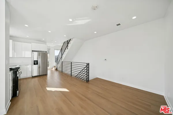 a kitchen with stainless steel appliances a stove sink and refrigerator