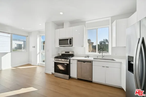 a bathroom with a granite countertop sink mirror vanity and toilet