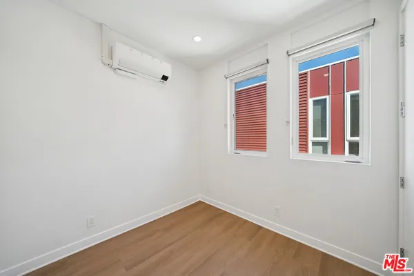 a utility room with a sink a toilet and a mirror