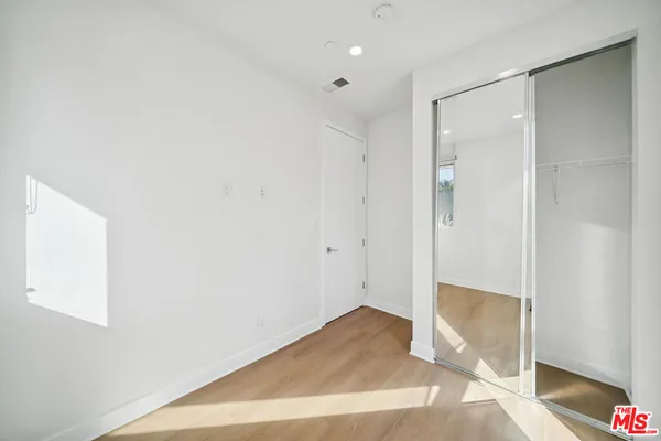 a bathroom with a shower sink vanity mirror and toilet