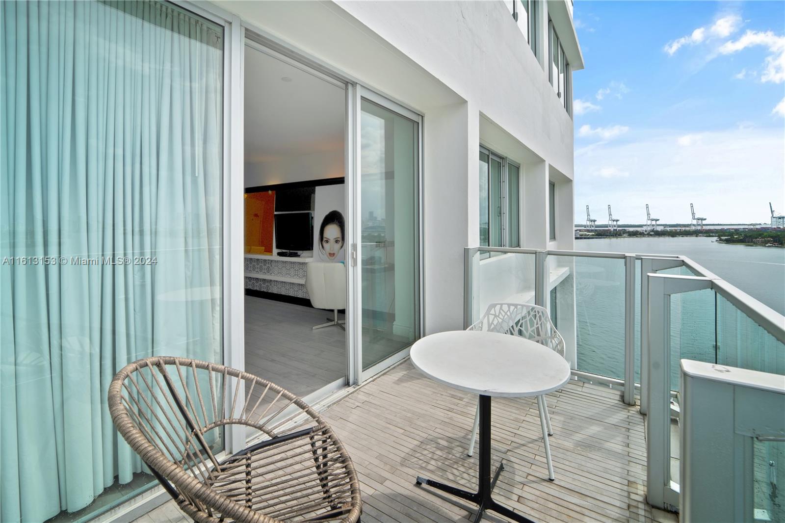 1100 West Avenue, Unit 1626 Miami Beach, FL 33139 - Photo 14 of 28 a balcony with table and chairs