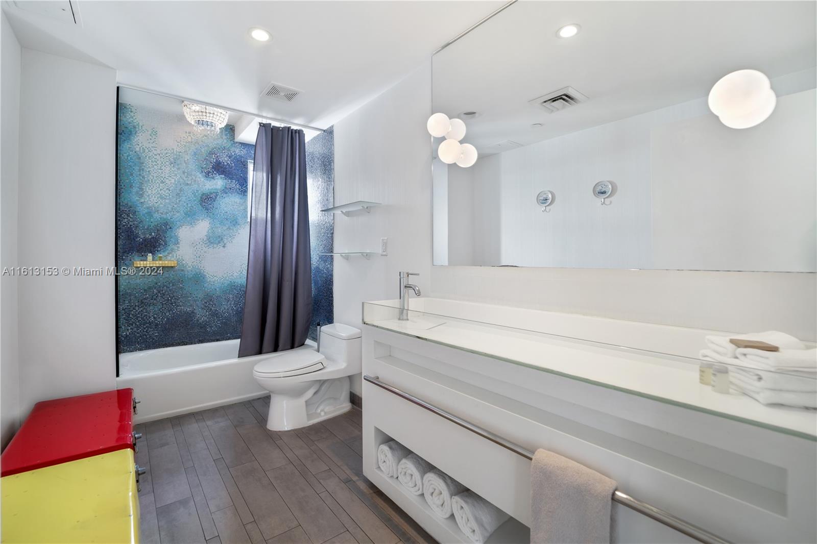 1100 West Avenue, Unit 1626 Miami Beach, FL 33139 - Photo 18 of 28 a bathroom with a bathtub shower sink mirror and toilet