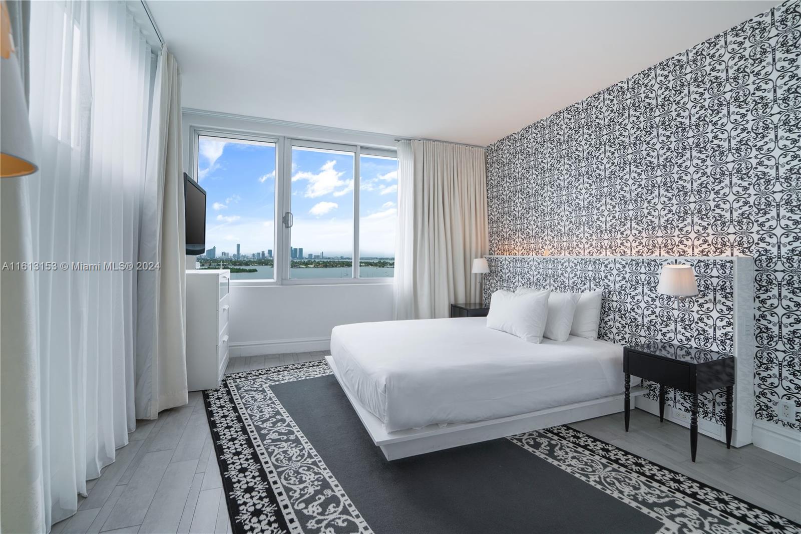 1100 West Avenue, Unit 1626 Miami Beach, FL 33139 - Photo 19 of 28 a bedroom with a bed rug and a window