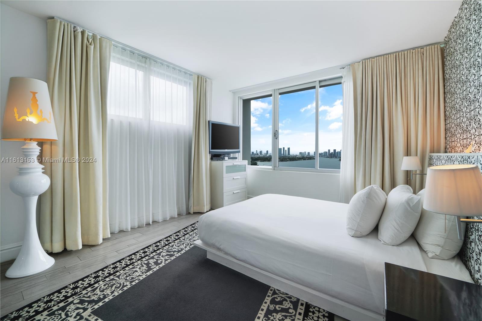 1100 West Avenue, Unit 1626 Miami Beach, FL 33139 - Photo 20 of 28 a bedroom with a bed and large window