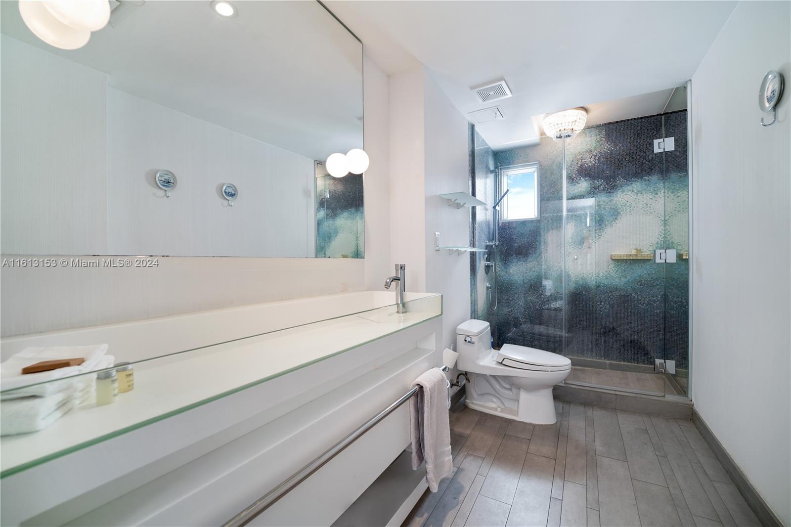 1100 West Avenue, Unit 1626 Miami Beach, FL 33139 - Photo 21 of 28 a bathroom with a sink a toilet and shower
