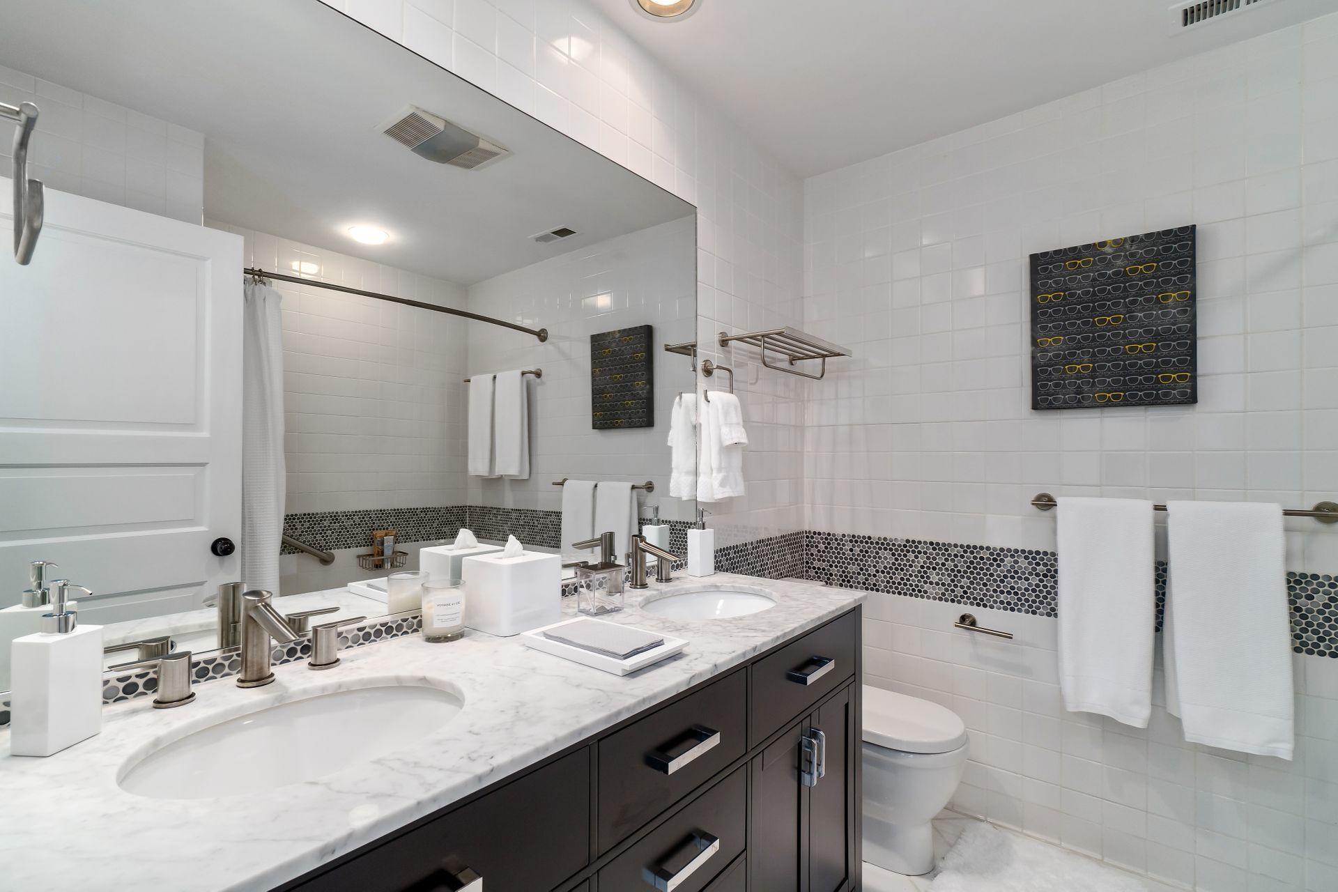 38 Farview Farm Road Redding, CT 06896 - Photo 21 of 34 a bathroom with a granite countertop sink a large mirror and a toilet