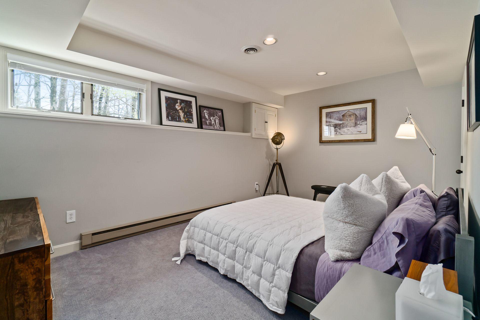 38 Farview Farm Road Redding, CT 06896 - Photo 24 of 34 a bedroom with a bed and the wall painting