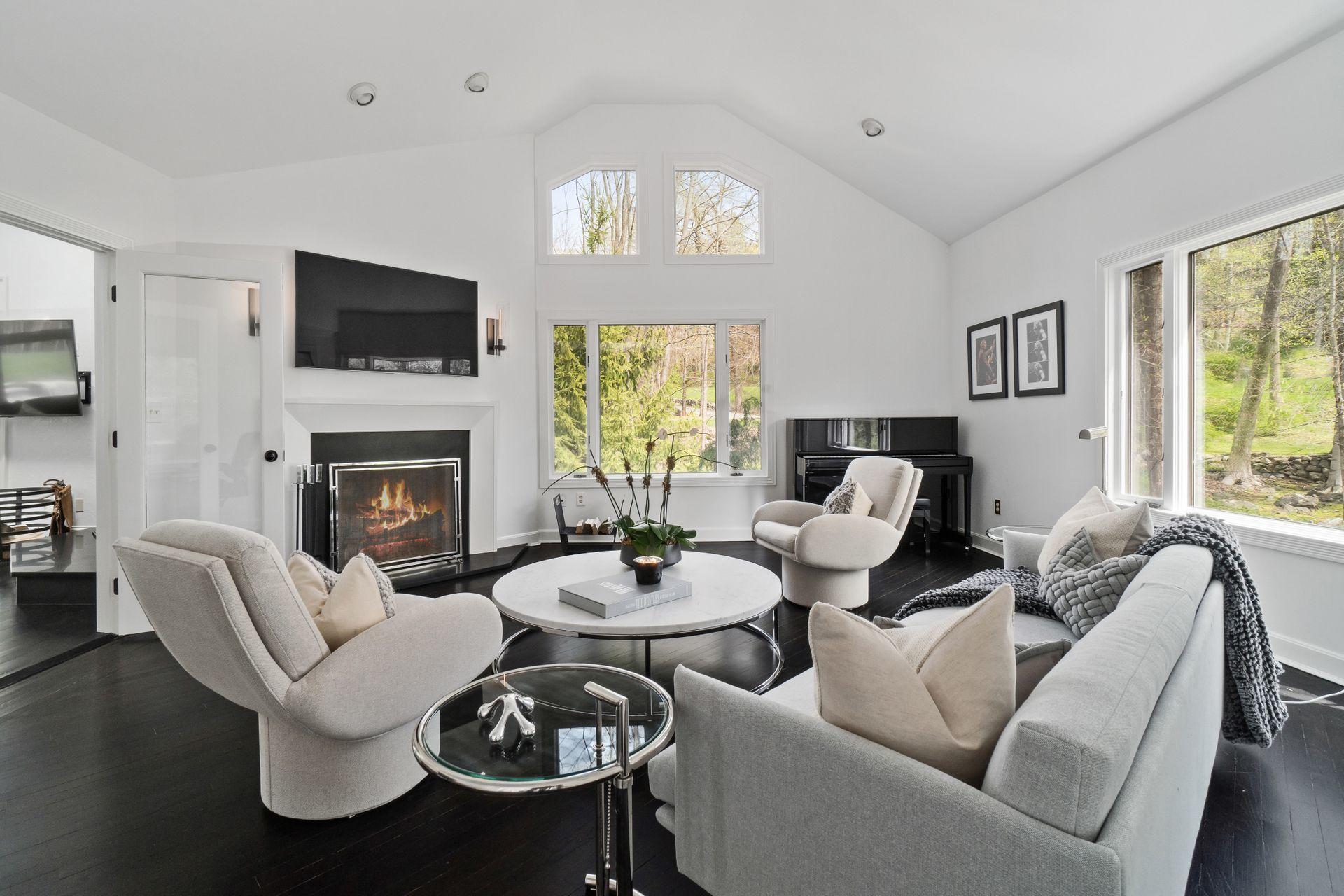 38 Farview Farm Road Redding, CT 06896 - Photo 5 of 34 a living room with furniture a fireplace and a flat screen tv