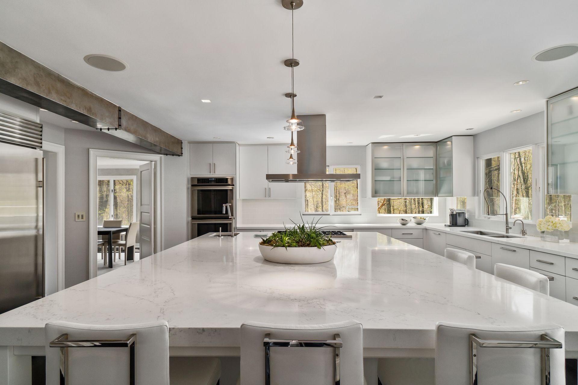 38 Farview Farm Road Redding, CT 06896 - Photo 8 of 34 a kitchen with kitchen island a sink table and chairs