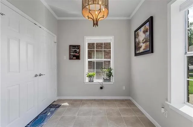 a kitchen with stainless steel appliances granite countertop a stove top oven a sink dishwasher and white cabinets