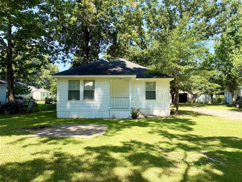 217 3rd St Pinehill Springhill, LA 71075 - Photo 2 of 23 White siding exterior with a dark shingle roof