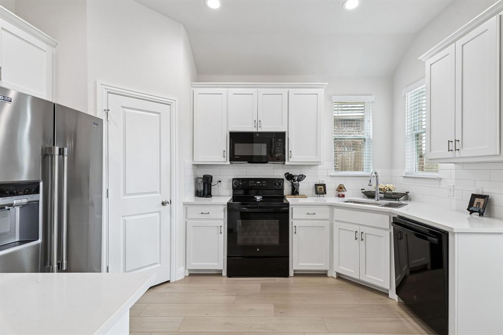 388 Montague Street Pilot Point, TX 76258 - Photo 11 of 28 a kitchen with a refrigerator stove and sink