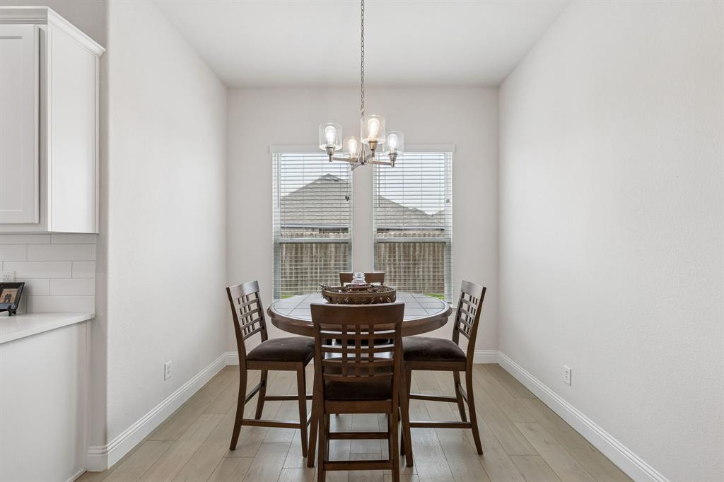 388 Montague Street Pilot Point, TX 76258 - Photo 14 of 28 a dining room with furniture a chandelier and a rug