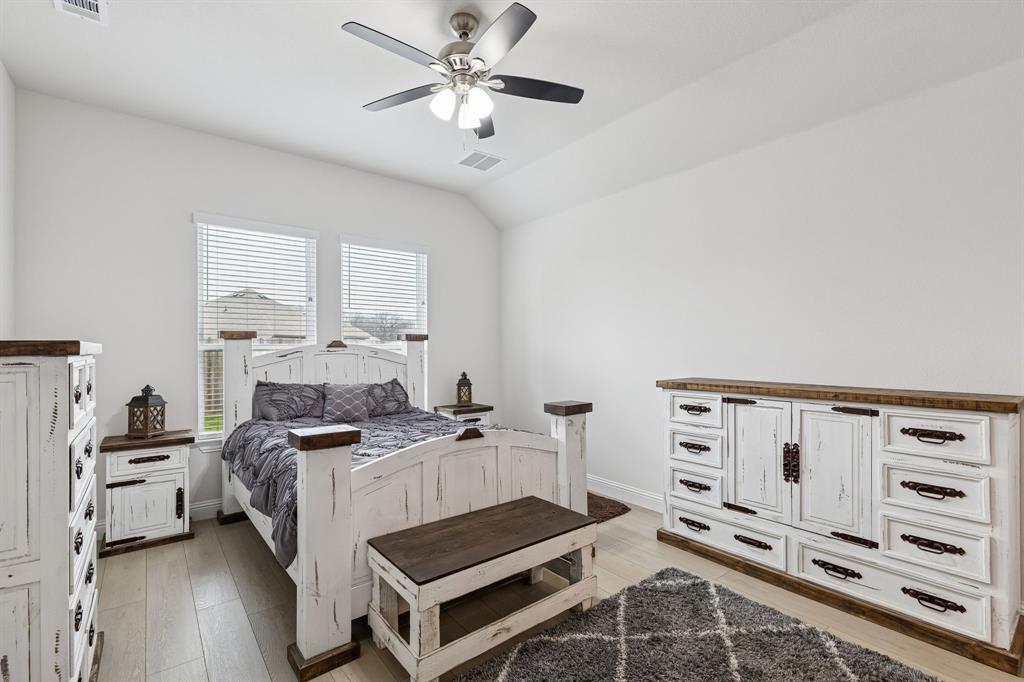 388 Montague Street Pilot Point, TX 76258 - Photo 17 of 28 a bedroom with a bed and a bookshelf