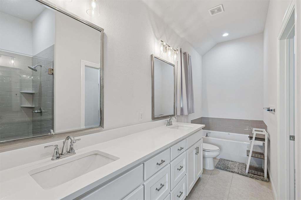 388 Montague Street Pilot Point, TX 76258 - Photo 20 of 28 a bathroom with a double vanity sink and a mirror