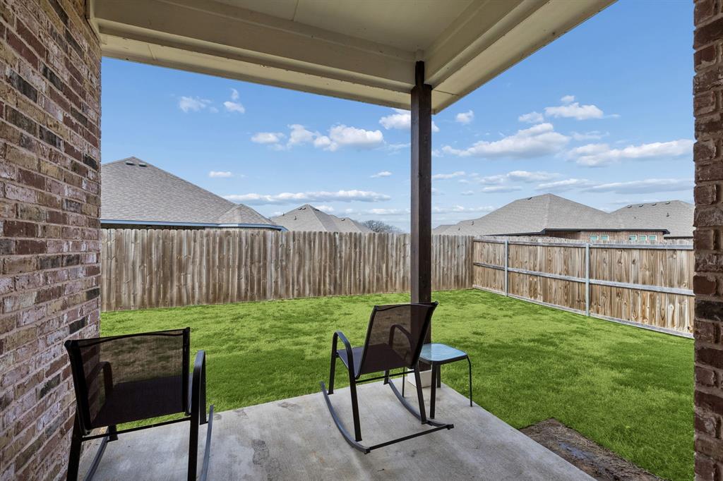 388 Montague Street Pilot Point, TX 76258 - Photo 26 of 28 a view of a chair and table in backyard next to a yard
