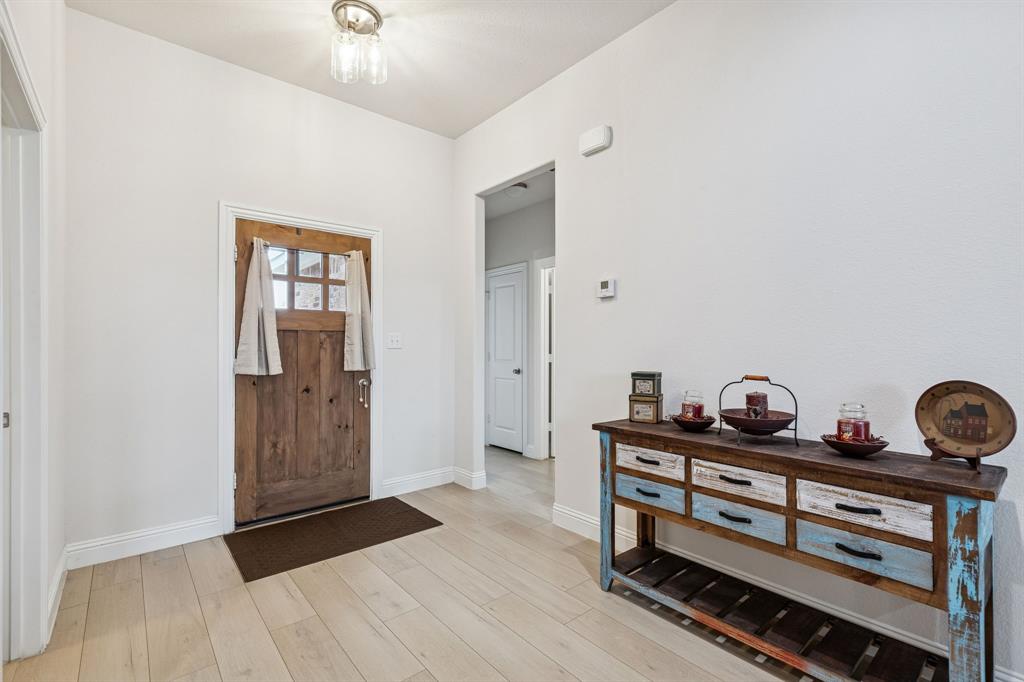 388 Montague Street Pilot Point, TX 76258 - Photo 5 of 28 a view of room with cabinets and wooden floor