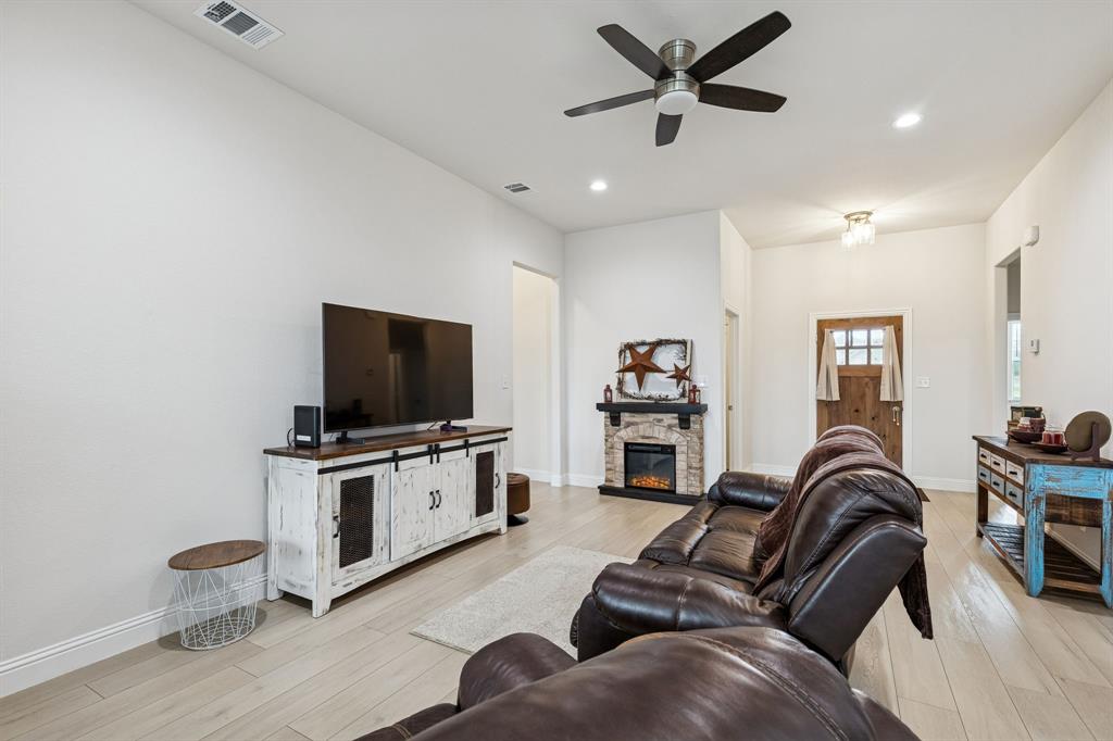 388 Montague Street Pilot Point, TX 76258 - Photo 6 of 28 a living room with furniture and a flat screen tv