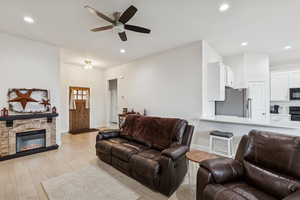 388 Montague Street Pilot Point, TX 76258 - Photo 7 of 28 a living room with furniture and a fireplace