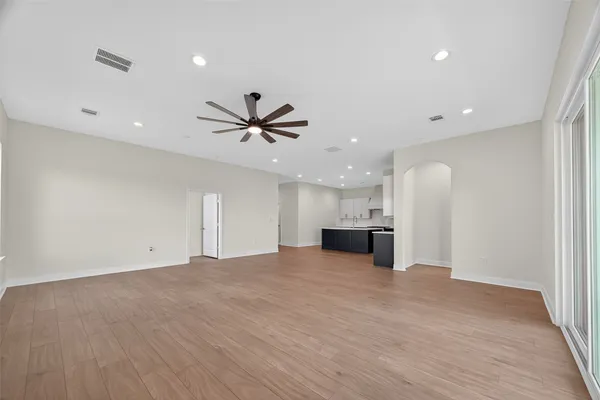 a kitchen with stainless steel appliances granite countertop a sink a stove a refrigerator and white cabinets