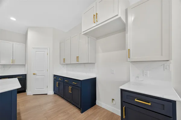 a kitchen with stainless steel appliances granite countertop a stove a sink and white cabinets