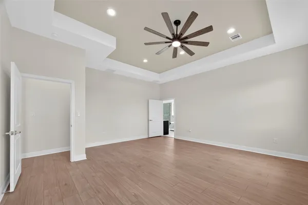 a view of a big room with wooden floor closet and windows