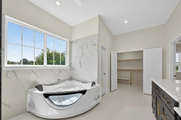 a spacious bathroom with a double vanity sink mirror and double