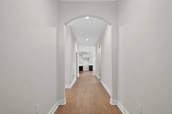 a view of hallway with wooden floor