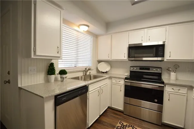 a kitchen with a sink stove and microwave