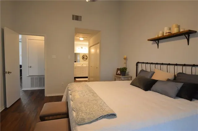 a bedroom with bed and wooden floor