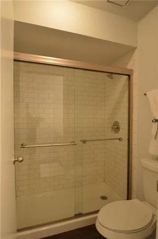 a bathroom with a toilet and a shower