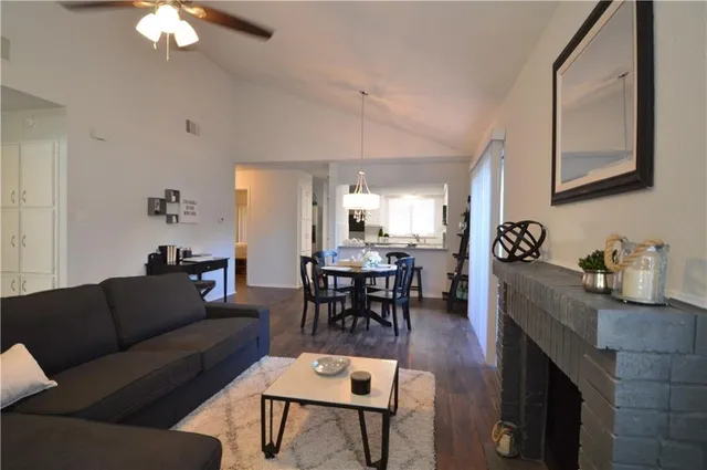 a living room with furniture and a dining table