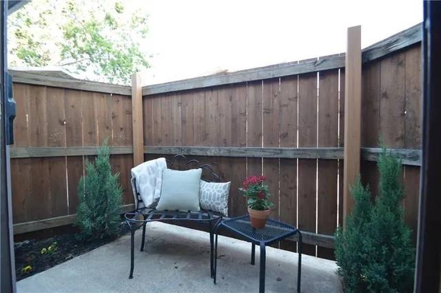 a backyard of a house with table and chairs