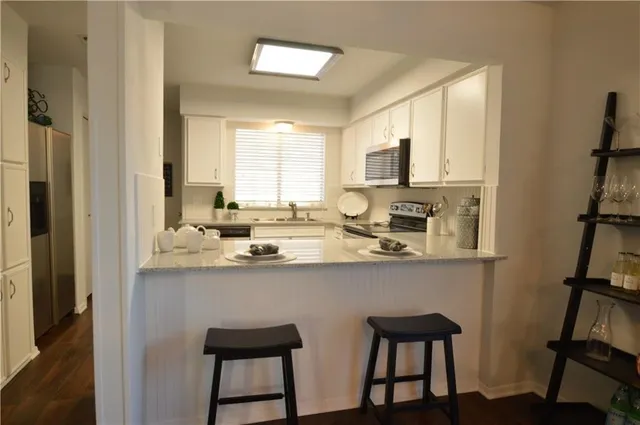 a kitchen with a sink and a refrigerator