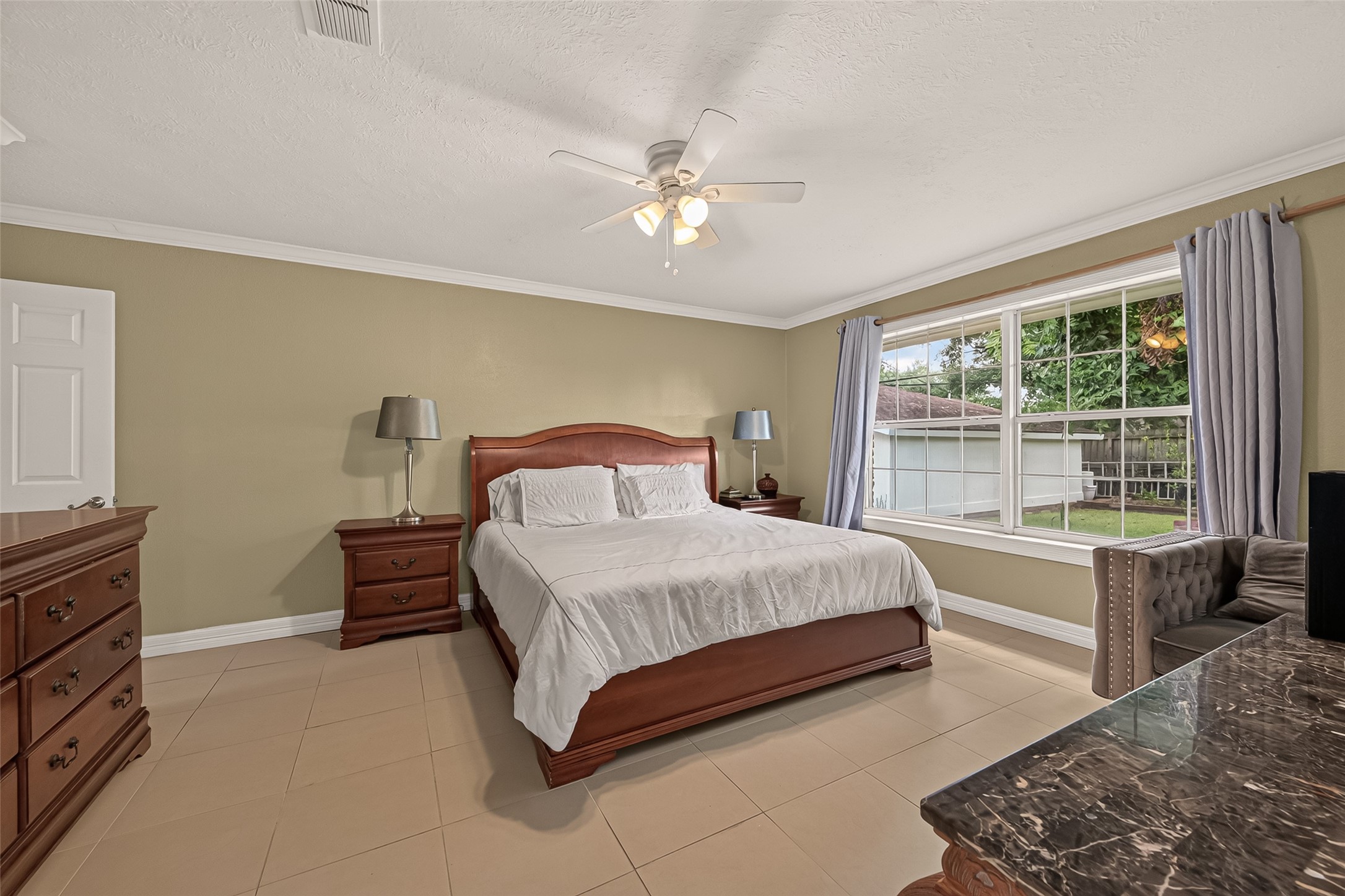 10807 Chimney Rock Road Houston, TX 77096 - Photo 26 of 35 Another view of the large primary bedroom. Such a pretty, large window with a lovely view of the backyard.