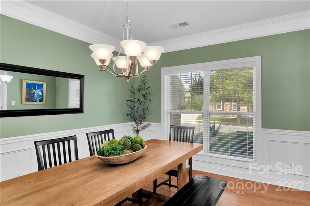1640 Ridgehaven Road Waxhaw, NC 28173 - Photo 13 of 36 a view of a dining room with furniture a chandelier and wooden floor
