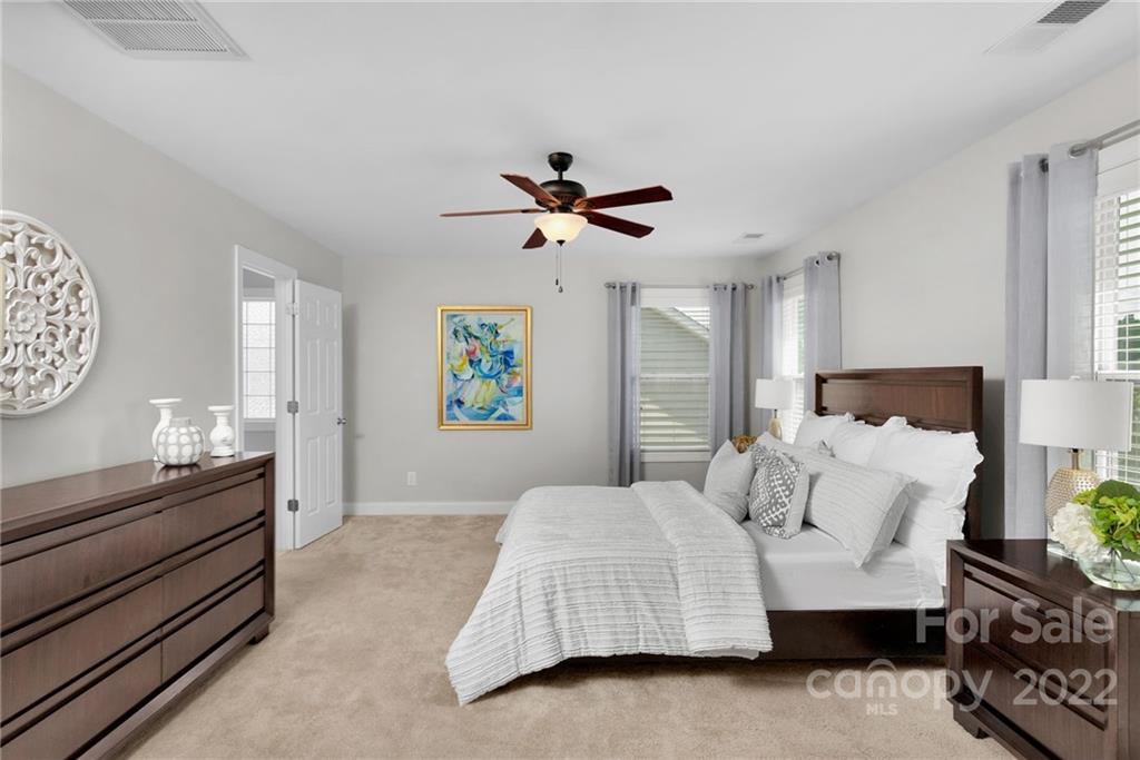 1640 Ridgehaven Road Waxhaw, NC 28173 - Photo 15 of 36 a bedroom with a bed and a chandelier