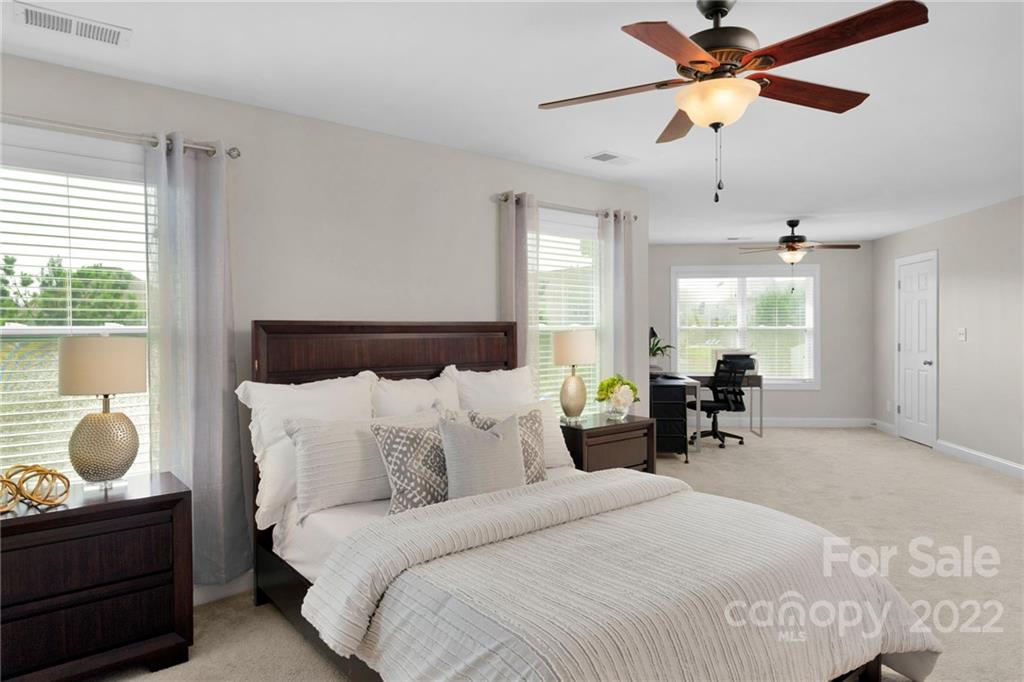 1640 Ridgehaven Road Waxhaw, NC 28173 - Photo 16 of 36 a bedroom with a bed and a chandelier