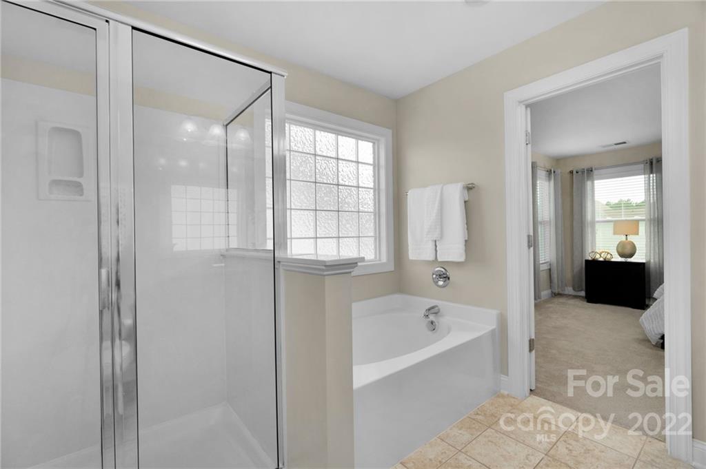 1640 Ridgehaven Road Waxhaw, NC 28173 - Photo 20 of 36 a bathroom with a bathtub shower and a sink