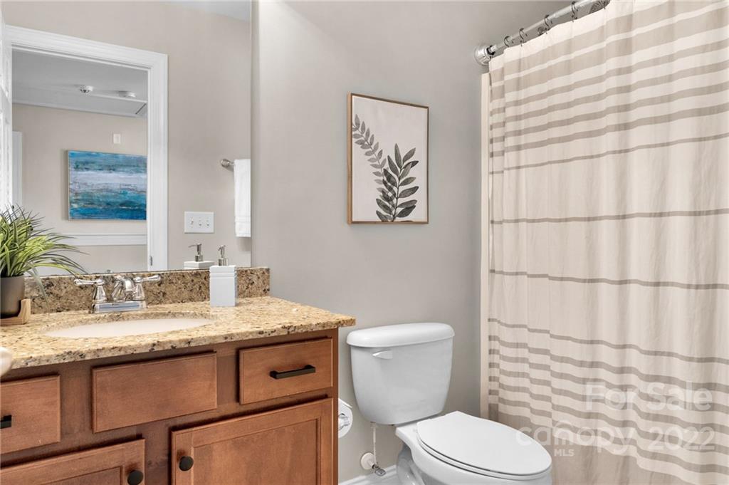 1640 Ridgehaven Road Waxhaw, NC 28173 - Photo 22 of 36 a bathroom with a granite countertop toilet sink and mirror