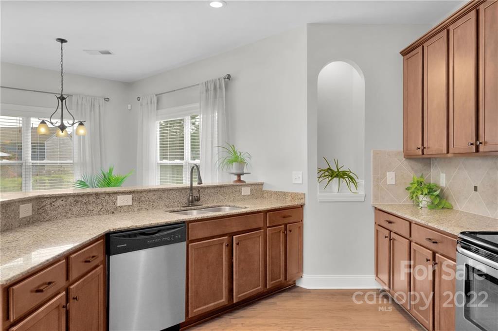1640 Ridgehaven Road Waxhaw, NC 28173 - Photo 6 of 36 a kitchen with stainless steel appliances granite countertop a sink a stove and a window