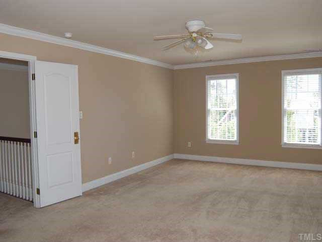 9308 Naples Court Raleigh, NC 27617 - Photo 6 of 12 A peaceful master bedroom offers neutral carpet, designer neutral wall paint, painted crown molding, ceiling fan with light, walk in closet and a French door entrance Other